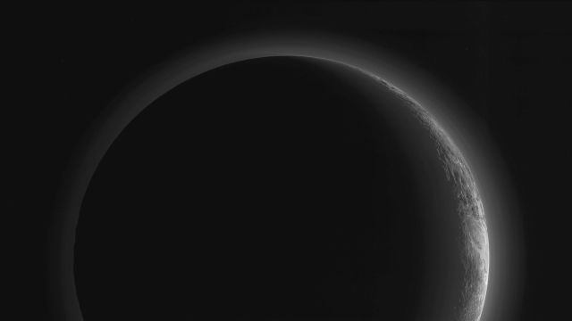 Planet Earth - Pluto's crescent: hazy skies and rugged ice mountains