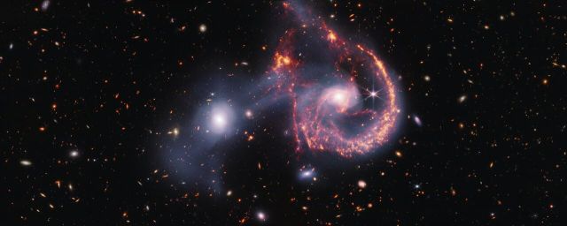 Space - Colliding galaxies in Arp 107 create cosmic smile