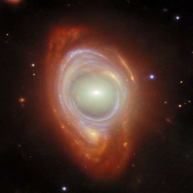 Space - Einstein ring: cosmic gravity bends a distant spiral